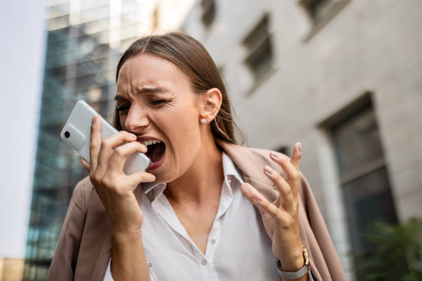 Businesswoman using phone shouting(Irritability )