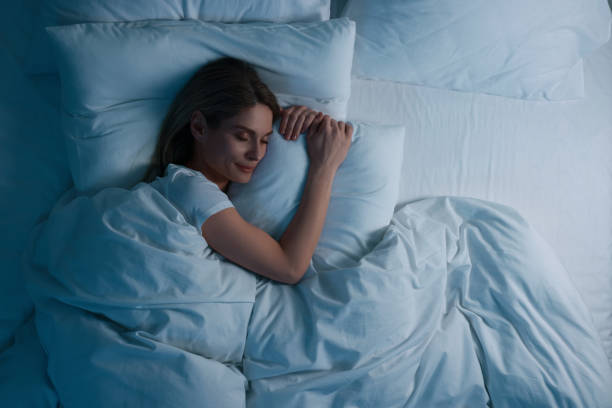Woman sleeping in bed at night, above view. feel a Hallucinations