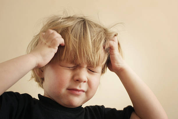 A four year old boy scratching his head from Vegetative-vascular dystonia (VVD)
