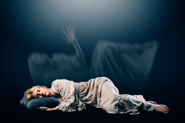 A woman sleeps as her translucent spirit makes an exit to mexplore other realms while she rests. Woman sleeping in Hallucinations
