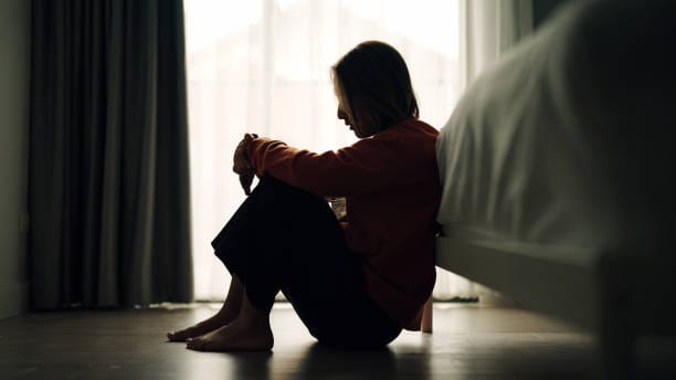 In silhouette of woman sad inhibition in bedroom.