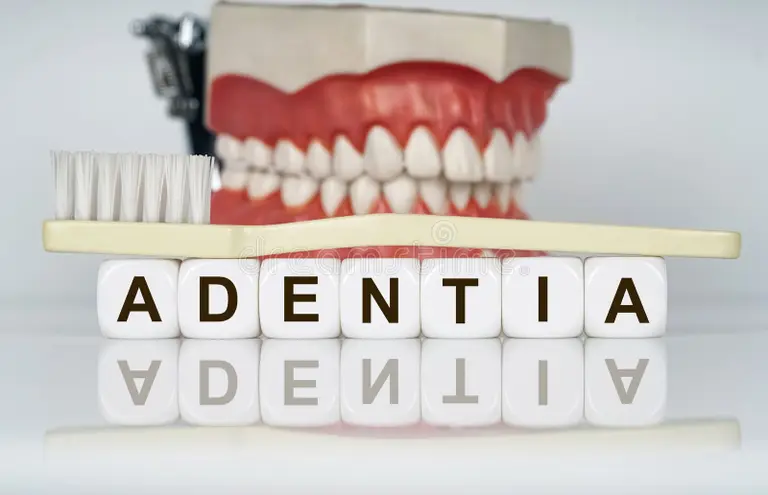 medical-dental-concept-text-written-cubes-adentia-background-model-jaw-toothbrush-prevention-diseases