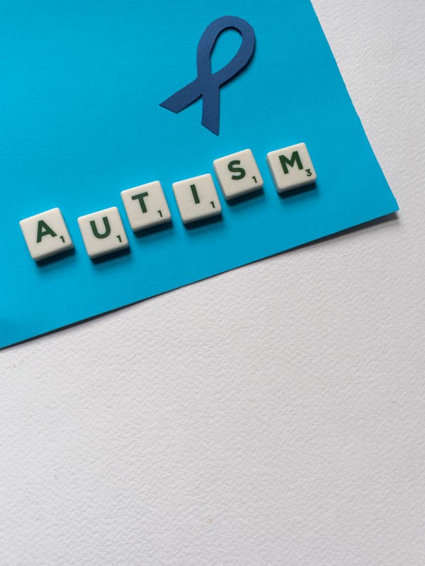 Autism on blue card with letters on it