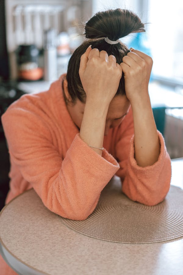 a person with their hands on their head